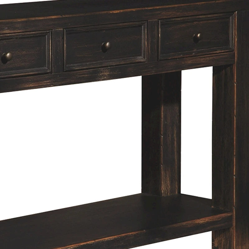Table basse en bois avec quatre tiroirs et une étagère, noir vieilli